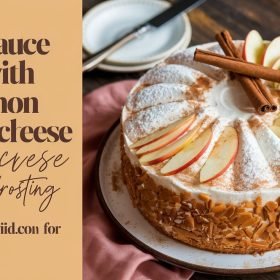 Layered applesauce cake with cinnamon cream cheese frosting topped with chopped pecans