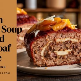 Comforting French onion soup stuffed meatloaf recipe served family-style on a wooden platter.