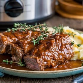 Perfectly braised slow cooker short ribs recipe served with crusty bread.