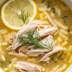 Classic Greek Lemon Chicken Soup featuring a clear, bright broth with orzo pasta and shredded chicken.