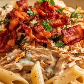 Rustic crack chicken penne plated beautifully with a drizzle of creamy sauce and a garnish of fresh parsley