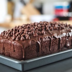 Close-up of hot fudge brownie bread showcasing a fudgy center with rich hot fudge swirls and a soft, cake-like texture.