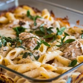 Chicken mozzarella pasta in a deep dish, showcasing layers of tender chicken, mozzarella, and a rich, flavorful sauce.
